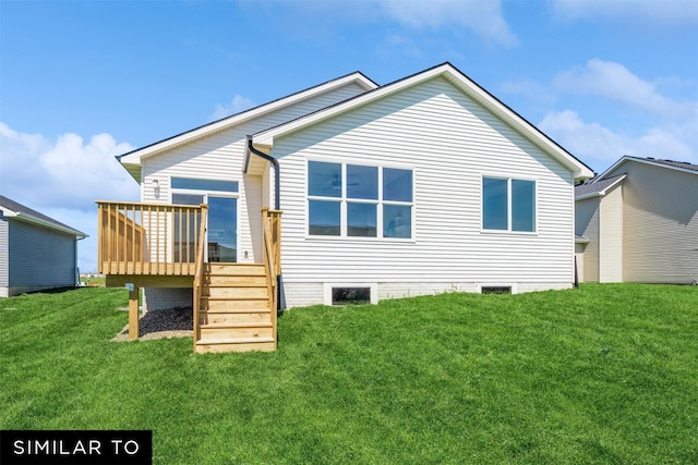 back of property featuring a deck and a lawn