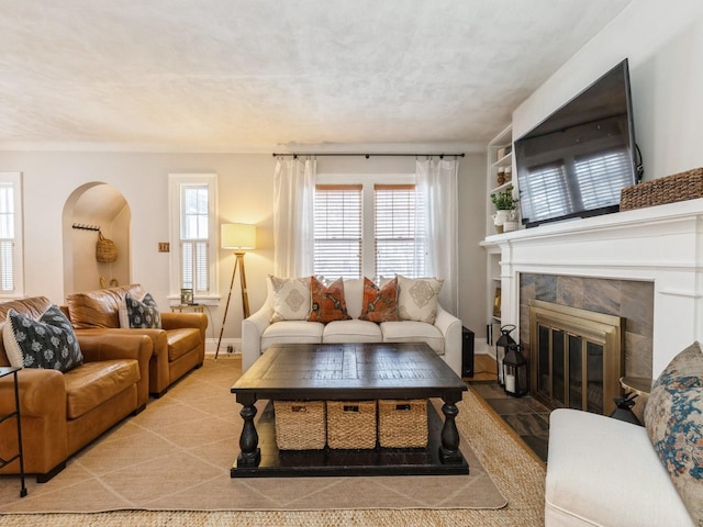 living room with plenty of natural light, a fireplace, and a textured ceiling