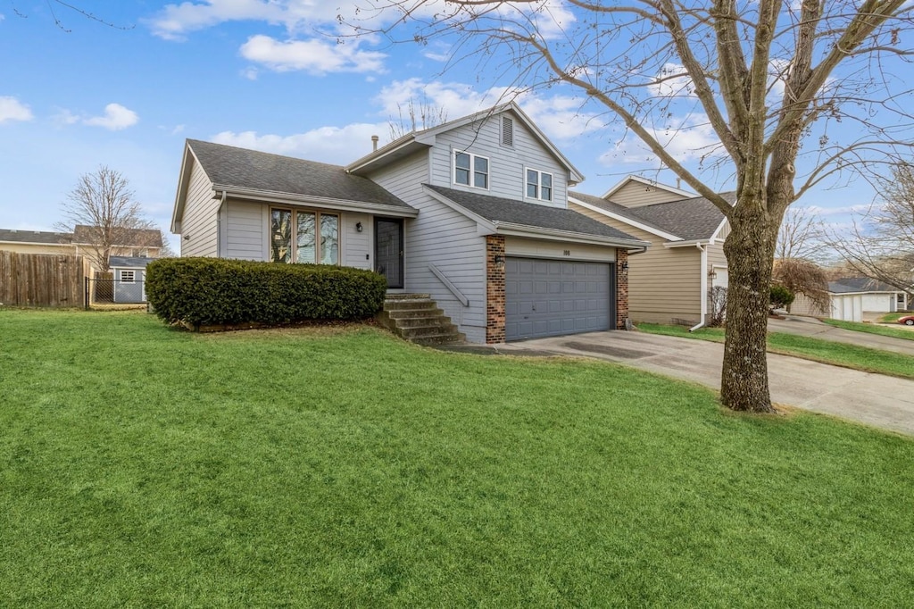 view of front of home with a garage and a front lawn