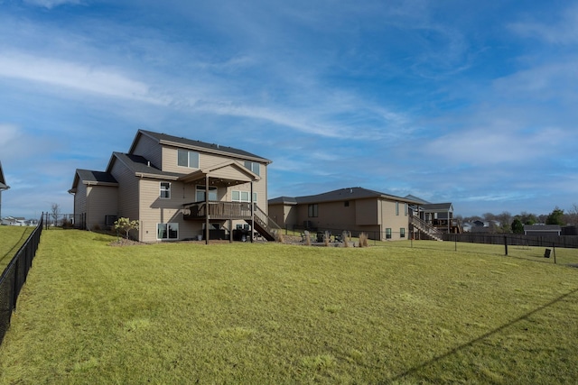 rear view of house with a deck and a lawn