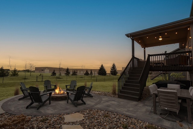 patio terrace at dusk with a yard and a fire pit