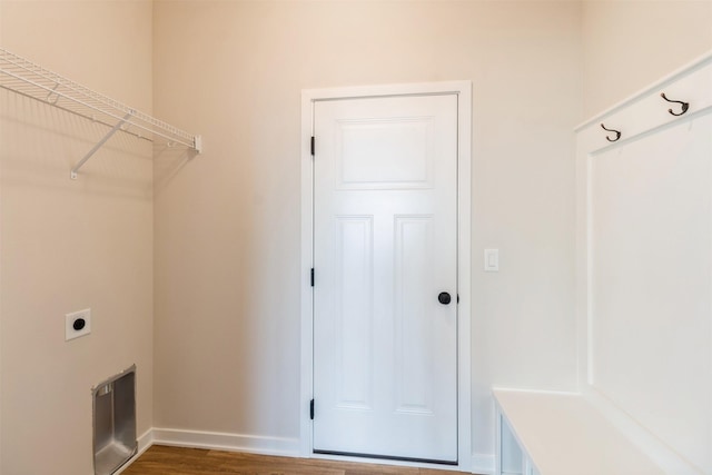 laundry area featuring dark hardwood / wood-style flooring and electric dryer hookup