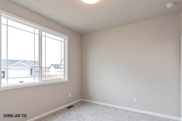 spare room with light colored carpet