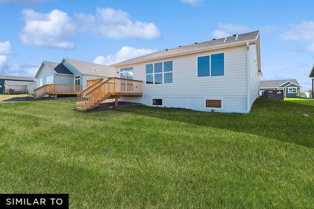 back of property featuring a wooden deck and a yard