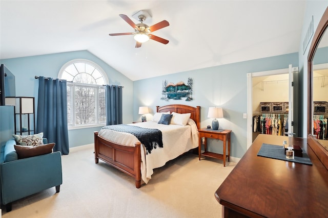 14102 Ridgemont Dr, Urbandale, IA 50323 - bedroom featuring light carpet, a spacious closet, lofted ceiling, a closet, and ceiling fan
