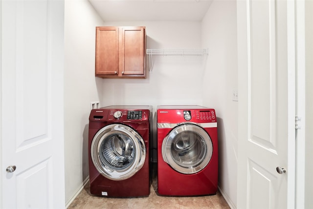 14102 Ridgemont Dr, Urbandale, IA 50323 - clothes washing area featuring cabinet space, washing machine and clothes dryer, and baseboards