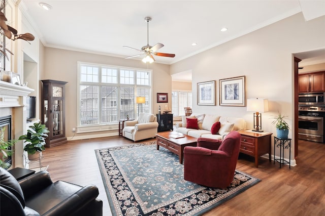 living room with wood finished floors, a wealth of natural light, and crown molding