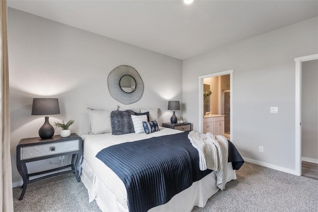 bedroom with carpet floors and connected bathroom