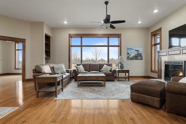 living room featuring light hardwood / wood-style floors and ceiling fan