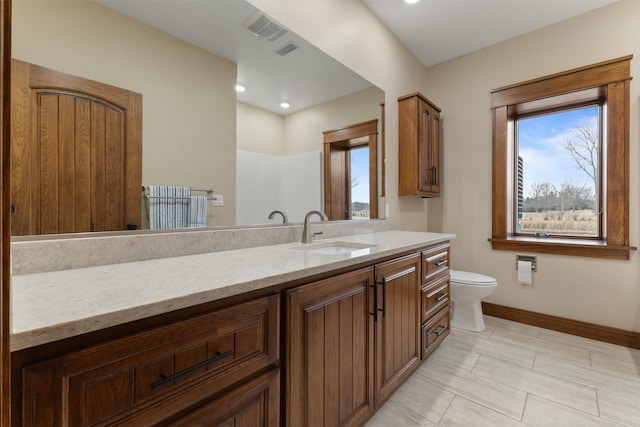 bathroom featuring vanity and toilet