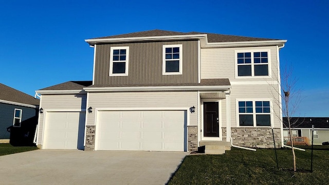 view of front of property featuring stone siding, an attached garage, and concrete driveway