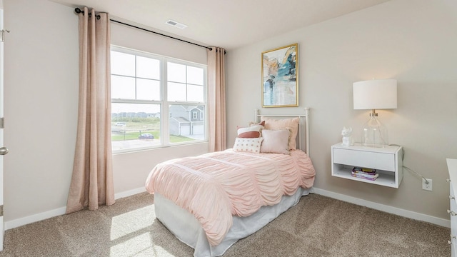 bedroom featuring light carpet