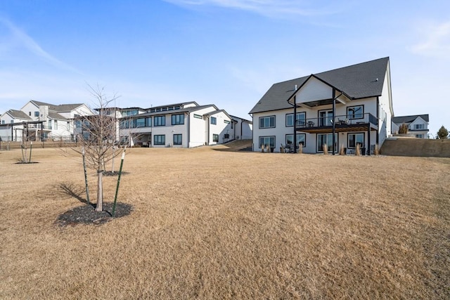 rear view of property featuring a lawn