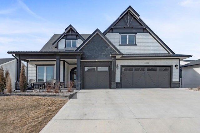 craftsman house with a garage and covered porch