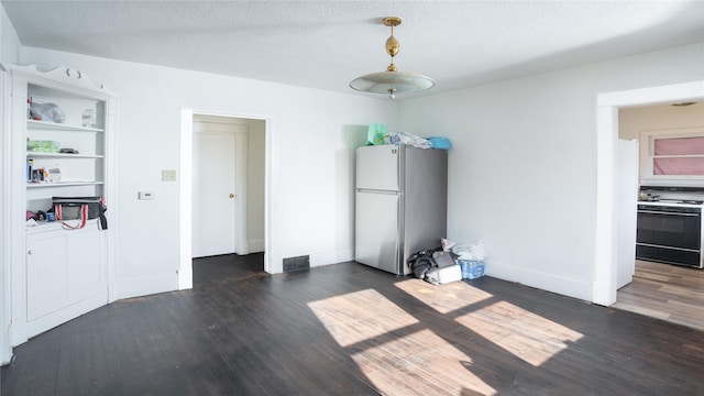 interior space featuring dark wood-type flooring and a textured ceiling