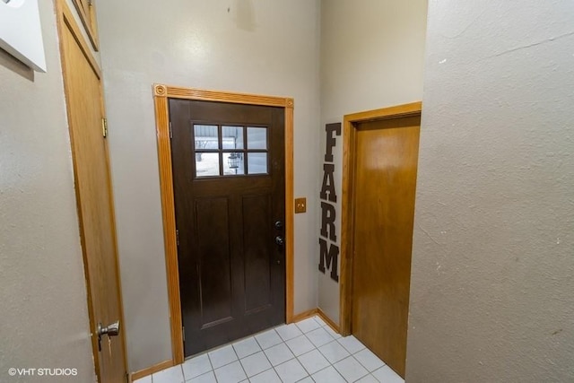 doorway to outside featuring light tile patterned floors