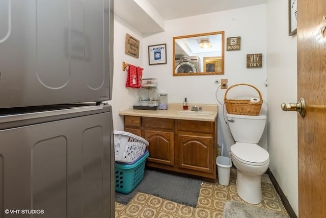 bathroom featuring vanity, tile patterned flooring, and toilet