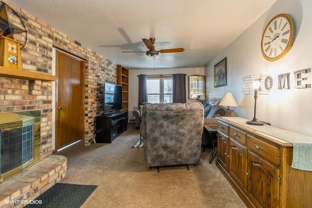 living room featuring ceiling fan, carpet flooring, a brick fireplace, and a textured ceiling