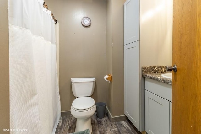 bathroom with vanity, hardwood / wood-style floors, and toilet