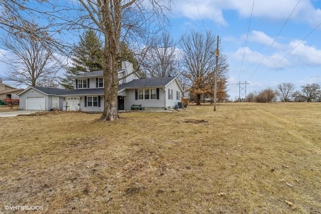 view of front of house featuring a garage and a front lawn