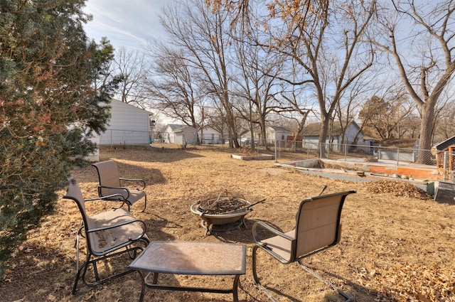 view of yard with a fire pit