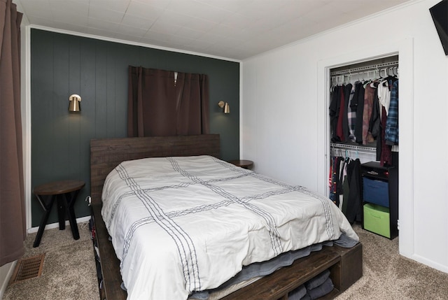 bedroom featuring ornamental molding, a closet, and carpet flooring