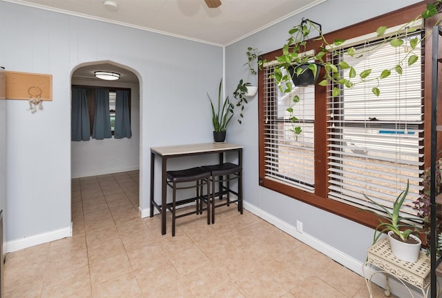 interior space featuring ornamental molding, light tile patterned floors, and ceiling fan