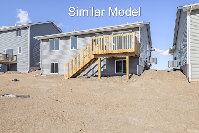 back of house featuring stairway, a deck, and central AC