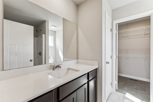 25116 Bluebird Cir, Adel, IA 50003 - bathroom with a shower, vanity, a spacious closet, and marble look tile flooring