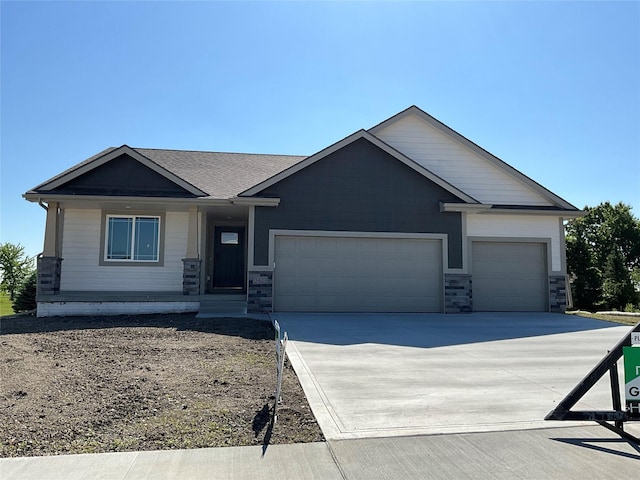 3423 5th Ave SE, Altoona, IA 50009 - view of front of property featuring a garage, driveway, and stone siding