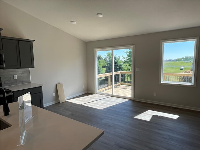 3423 5th Ave SE, Altoona, IA 50009 - unfurnished dining area featuring dark wood-style floors and baseboards