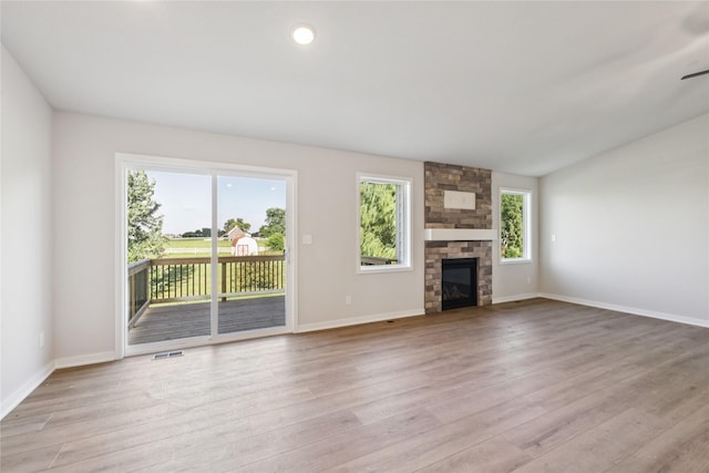 3423 5th Ave SE, Altoona, IA 50009 - unfurnished living room featuring plenty of natural light, wood finished floors, and a fireplace
