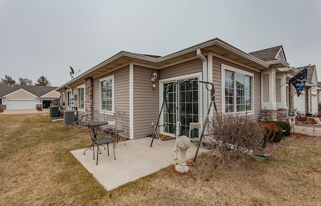 rear view of property featuring a patio, cooling unit, and a lawn