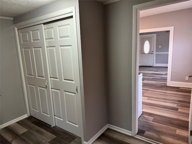 hall featuring dark hardwood / wood-style flooring and a textured ceiling