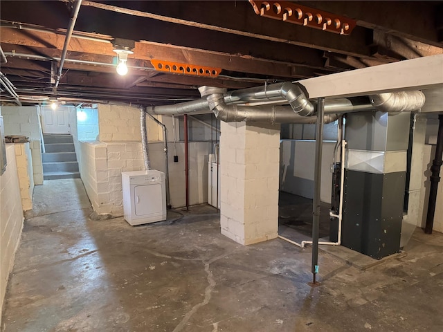 basement with washer / clothes dryer and heating unit