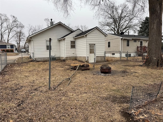 rear view of house with an outdoor fire pit