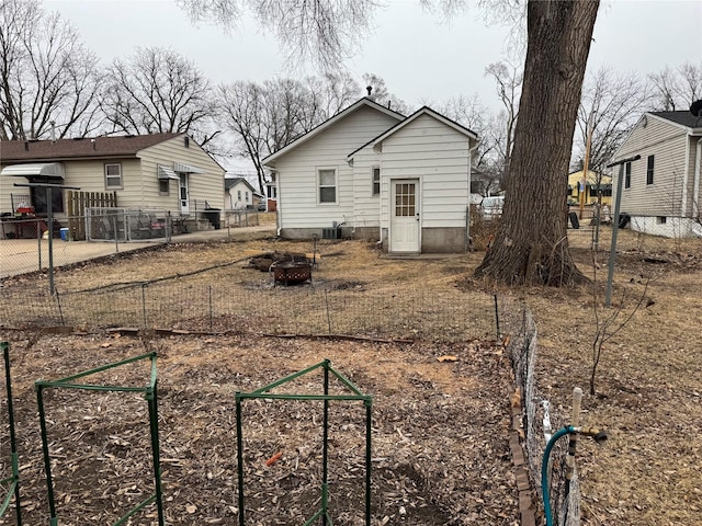 rear view of house with an outdoor fire pit