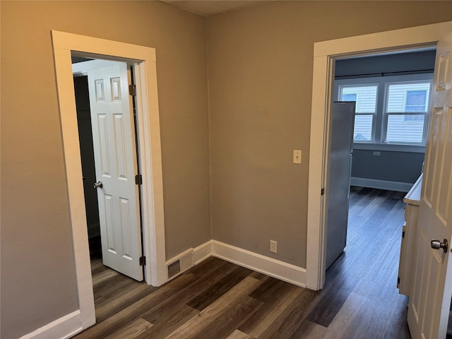 unfurnished room featuring dark hardwood / wood-style flooring