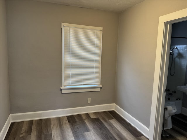 empty room featuring dark hardwood / wood-style flooring