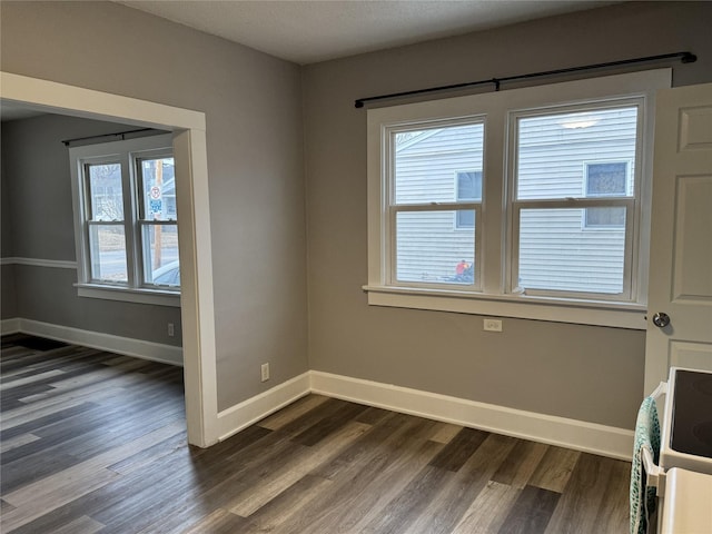 spare room featuring dark hardwood / wood-style flooring