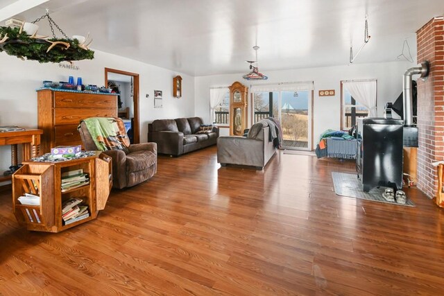 living room with a wood stove and hardwood / wood-style floors