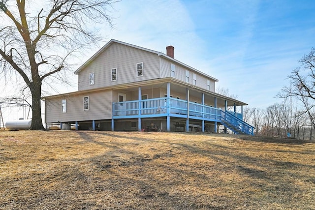 rear view of property featuring covered porch