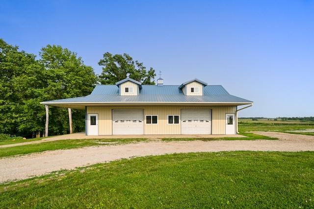2466 655th Ave, Albia, IA 52531 - view of front of property featuring driveway, a garage, a front lawn, and metal roof