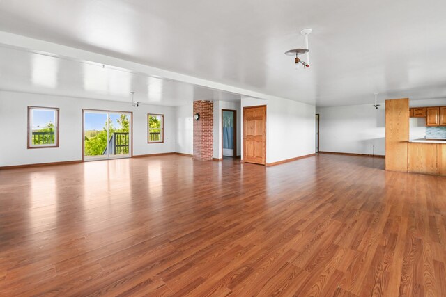 2466 655th Ave, Albia, IA 52531 - unfurnished living room with baseboards and wood finished floors