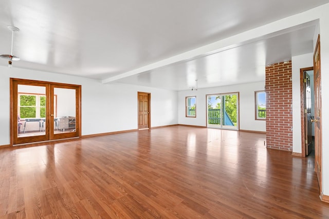 2466 655th Ave, Albia, IA 52531 - unfurnished living room with healthy amount of natural light, wood finished floors, and french doors