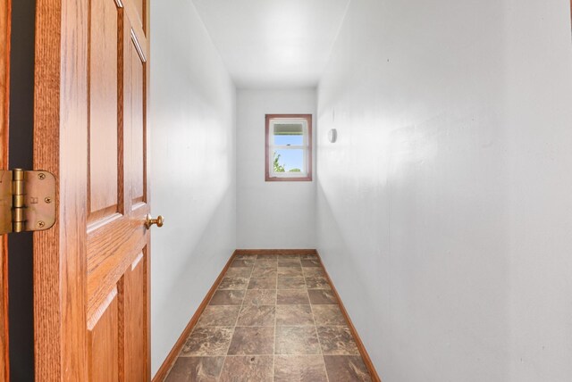 2466 655th Ave, Albia, IA 52531 - hallway featuring stone finish flooring and baseboards