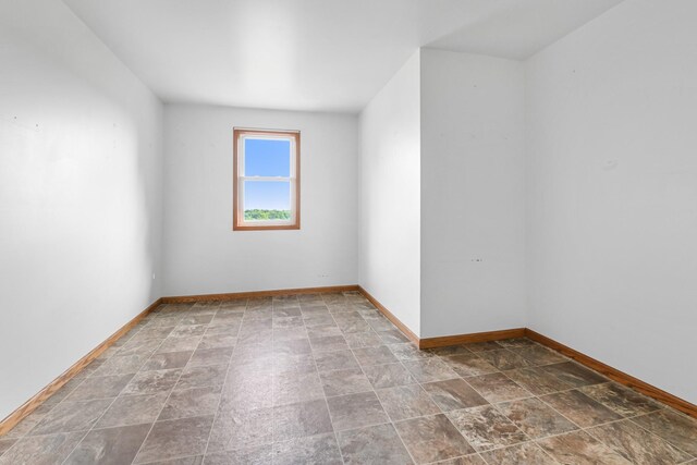 2466 655th Ave, Albia, IA 52531 - spare room with stone finish floors and baseboards