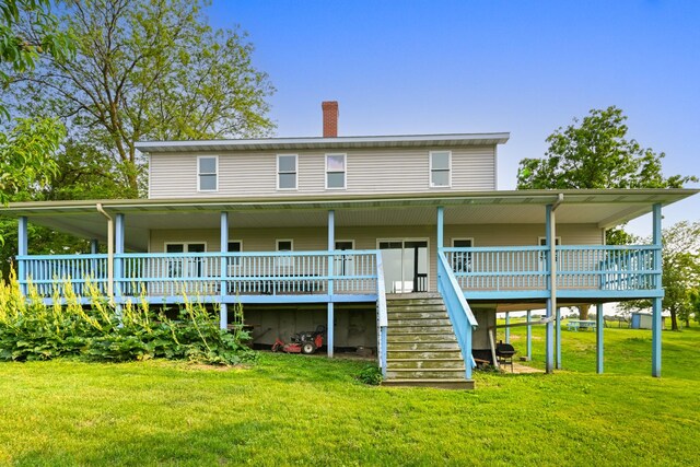 2466 655th Ave, Albia, IA 52531 - rear view of house with stairway, a yard, a chimney, and a wooden deck