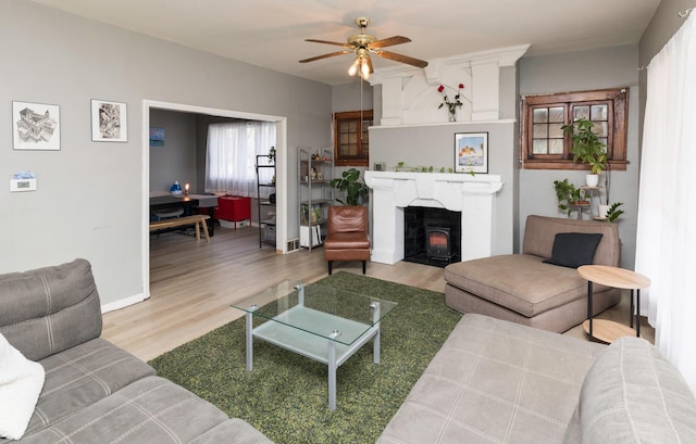 living room with hardwood / wood-style flooring and ceiling fan