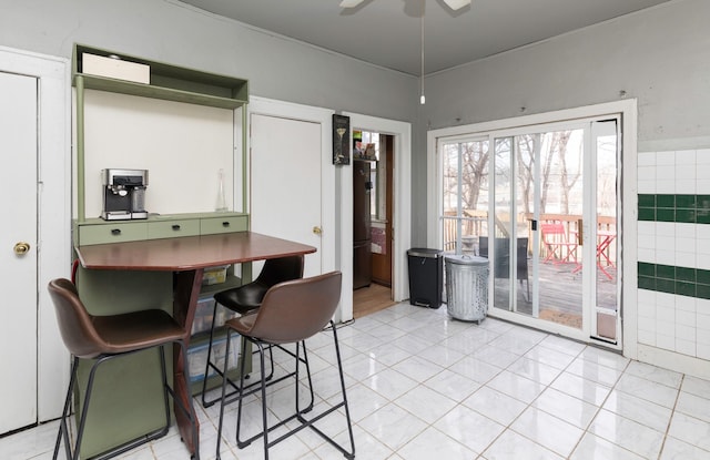 tiled dining space featuring ceiling fan